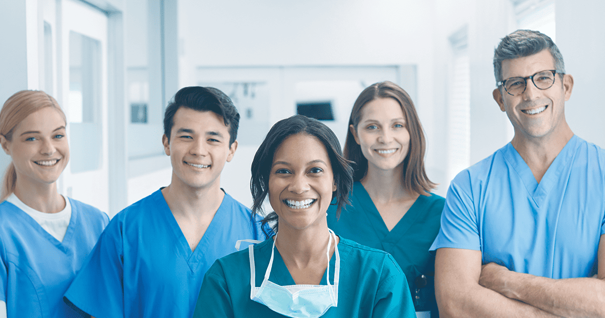 A Medical team looking at the camera and smiling.